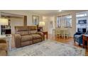 Living room filled with furniture and light, thanks to lots of windows at 13631 E Marina Dr # 109, Aurora, CO 80014
