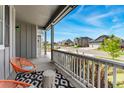 Inviting front porch with seating, offering neighborhood views and a relaxing outdoor space at 10968 Lewiston St, Commerce City, CO 80022