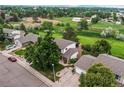 Aerial view showcases a well-maintained home with mature trees and landscaping in a desirable neighborhood at 10137 W Berry Dr, Littleton, CO 80127
