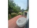 Relaxing deck featuring a comfortable chair and a view of the landscaped backyard at 2281 Fairplay St, Aurora, CO 80011