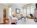 Elegant living room with hardwood floors, neutral tones, and an open doorway to a luxurious bathroom at 7600 Landmark Way # 613-2, Greenwood Village, CO 80111