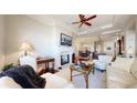 Cozy living room with fireplace, hardwood floors, and open view to the dining and kitchen area at 7600 Landmark Way # 613-2, Greenwood Village, CO 80111