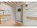Inviting front door with wreath and modern exterior light fixture at 7369 S Gore Range Rd # 208, Littleton, CO 80127