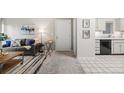 Cozy living room with stylish furniture and a view into the kitchen at 7369 S Gore Range Rd # 208, Littleton, CO 80127