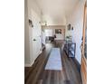 Welcoming foyer with hardwood floors and easy access to a cozy living area at 676 Hearthstone Ave, Brighton, CO 80601