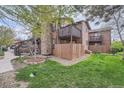 Multi-level townhome featuring a stone chimney and private wooden balconies at 9556 W 89Th Cir, Broomfield, CO 80021