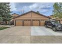Four-car garage featuring brown doors and driveway, offering ample parking space at 9556 W 89Th Cir, Broomfield, CO 80021