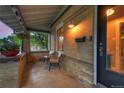 Relaxing front porch with comfortable chairs, plants, and brick pillars at 1172 Harrison St, Denver, CO 80206