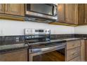 Close up on the new stainless steel range and oven and granite counter tops at 497 Valley Way, Bennett, CO 80102