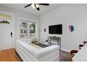 Bright living room with hardwood floors, a large window, modern decor, and a comfortable white sofa at 2424 N Clay St, Denver, CO 80211