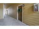Apartment entrance featuring a brown door with a green wreath and numbered E18 at 6021 W Castlegate Dr # E18, Castle Rock, CO 80108
