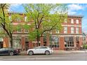 Beautiful three-story brick building with large windows and mature trees in front at 3211 Zuni St # 14, Denver, CO 80211