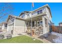 Two-story house with gray siding, brick accents, and a landscaped front yard at 7888 Tejon St, Denver, CO 80221