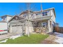 Charming two-story home with well-manicured lawn, porch decorations, an American flag, and a two-car garage at 7888 Tejon St, Denver, CO 80221