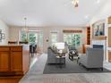 Comfortable living room featuring an open layout with a fireplace and dining area at 1185 S Kramer Ct, Aurora, CO 80012