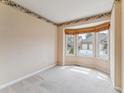Inviting office space with large bay window and neutral carpet at 1185 S Kramer Ct, Aurora, CO 80012