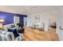Stylishly furnished living room showcasing hardwood floors, a blue accent wall, and ample natural light at 1279 Leyden St, Denver, CO 80220