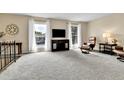 Bright living room with plush carpet, large windows, and comfortable seating at 16025 E Warren Pl, Aurora, CO 80013