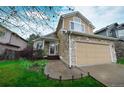 Charming two-story home with stone and siding, featuring a two-car garage and well-kept front yard at 3565 W 112Th Cir, Westminster, CO 80031