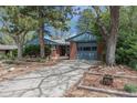 Inviting single-story home with brick accents, mature trees, landscaping and attached garage at 120 Field St, Lakewood, CO 80226