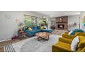 Bright living room with stylish furniture, brick fireplace, and an inviting open layout at 120 Field St, Lakewood, CO 80226