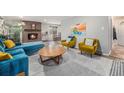 Bright living room with stylish furniture, brick fireplace, and an inviting open layout at 120 Field St, Lakewood, CO 80226