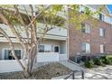 Brick exterior, two-story condo with small porch and view at 10149 W 55Th Dr # 3, Arvada, CO 80002