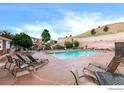 Community pool with lounge chairs and landscaped surroundings in a relaxing setting at 10149 W 55Th Dr # 3, Arvada, CO 80002