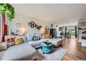 Inviting living room with a large sectional sofa, wood floors, and stylish decor at 18662 E Brown Pl, Aurora, CO 80013
