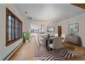 Elegant dining room with chandelier, hardwood floors and window featuring view of the outdoors at 371 Birch St, Denver, CO 80220