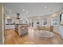 Spacious, well-lit kitchen with island seating, stainless steel appliances, and casual dining area at 371 Birch St, Denver, CO 80220