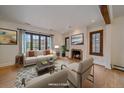 Bright living room with hardwood floors, fireplace, and large windows offering natural light at 371 Birch St, Denver, CO 80220