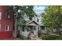 Lovely two-story home with mature trees, a well-maintained yard, and a welcoming front porch in a quiet neighborhood at 1266 N Pearl St, Denver, CO 80203