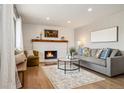 Inviting living room featuring a cozy fireplace, hardwood floors, and ample natural light at 1667 S Balsam Ct, Lakewood, CO 80232