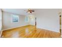 Bright living room with hardwood floors, plenty of natural light and a ceiling fan at 415 S Parfet St, Lakewood, CO 80226