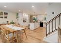 Bright, open kitchen with island, stainless appliances, white cabinetry, and adjoining dining area at 10527 Pierson Cir, Westminster, CO 80021