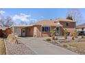 Spacious driveway leading to a well-maintained brick home with an attached garage at 2567 S Vrain St, Denver, CO 80219