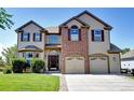 Charming two-story home featuring a brick facade and an attached two-car garage at 11951 Singing Winds St, Parker, CO 80138