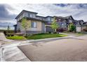 Houses with gray siding and stone accents in a residential community at 11099 Pastel Pt, Parker, CO 80134