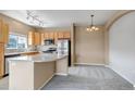 Bright kitchen with stainless steel appliances and eat in dining area at 9387 Ashbury Cir # 203, Parker, CO 80134