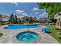 Community pool and hot tub with plenty of seating at 9387 Ashbury Cir # 203, Parker, CO 80134
