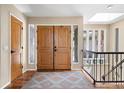 Inviting foyer features hardwood floors, wooden double doors, and a staircase with iron railings at 1555 Genesee Ridge Rd, Golden, CO 80401