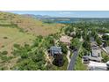 Wide aerial shot showcasing the house with a lake in the background at 14150 Foothill Ln, Golden, CO 80401
