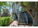 Close-up of the home's exterior with modern staircase and landscaped path at 14150 Foothill Ln, Golden, CO 80401