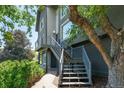 View of the exterior of a multi-level home showcasing a staircase and small balcony at 14150 Foothill Ln, Golden, CO 80401