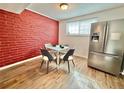 Cozy dining area featuring a table with four chairs and a stainless steel refrigerator at 6800 E Tennessee Ave # 351, Denver, CO 80224