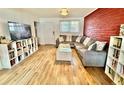 Modern living room boasts wood floors, a comfortable sectional sofa, and built-in bookshelves for storage at 6800 E Tennessee Ave # 351, Denver, CO 80224