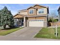 Traditional two-story home with a manicured lawn and a spacious two-car garage at 2736 Poplar Grove Pl, Castle Rock, CO 80109