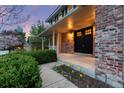 Charming home entrance featuring a cozy porch with a black double door and lovely front garden at 8132 Lodgepole Trl, Lone Tree, CO 80124