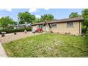 Beautiful brick home featuring a front yard with fresh green grass at 12167 E Exposition Ave, Aurora, CO 80012